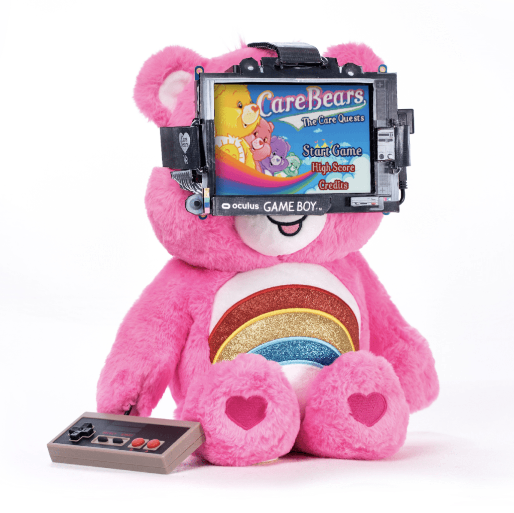 a pink rainbow care bear wearing a screen as goggles which shows the care bears game playing on it